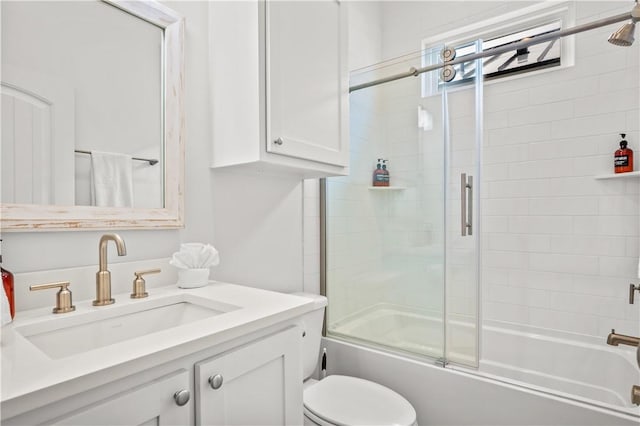 full bathroom featuring vanity, shower / bath combination with glass door, and toilet