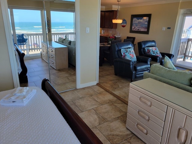 living room with a water view and ornamental molding