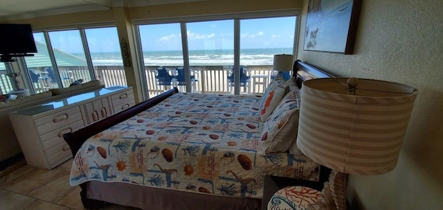 tiled bedroom featuring ornamental molding, multiple windows, a water view, and access to outside