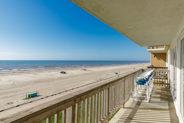 balcony with a beach view and a water view