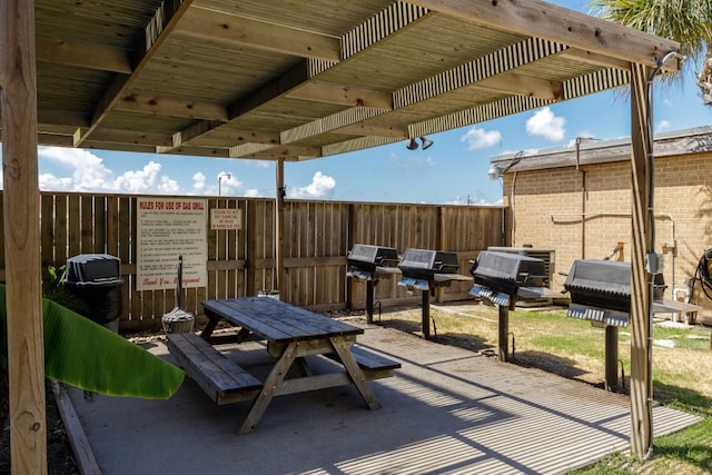 view of patio with grilling area and a pergola