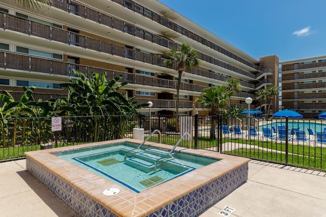 view of pool with a community hot tub