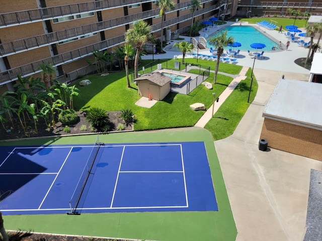 view of tennis court with a community pool