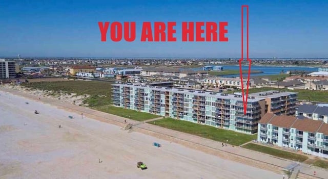 aerial view featuring a view of the beach and a water view