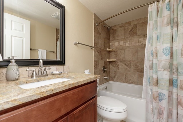 full bathroom with shower / tub combo with curtain, vanity, and toilet