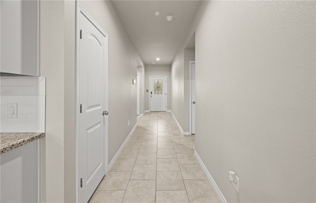 hallway with light tile patterned floors