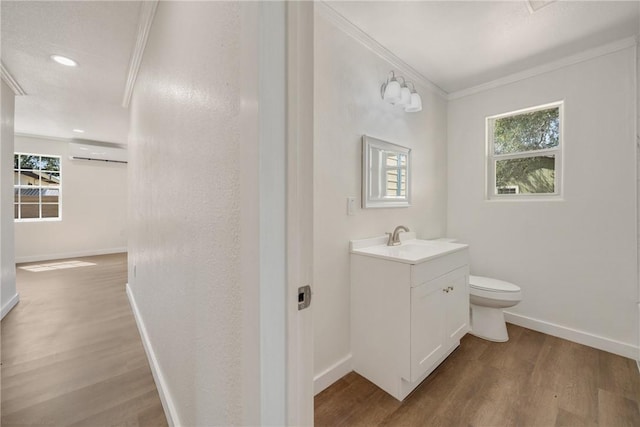 5506 Curtis Clark Dr, Corpus Christi, TX 78411 - bathroom featuring wood finished floors, vanity, crown molding, plenty of natural light, and recessed lighting