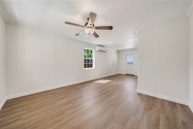 spare room with hardwood / wood-style floors, a wall unit AC, ceiling fan, and ornamental molding