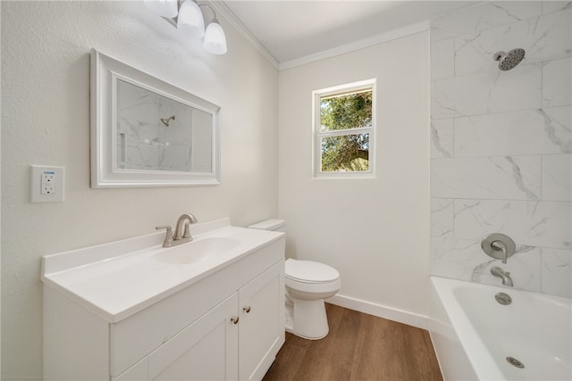 full bathroom with wood-type flooring, crown molding, vanity, toilet, and tiled shower / bath