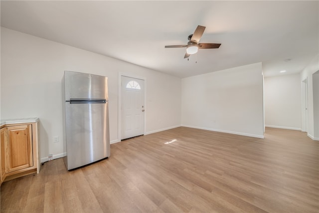 unfurnished living room featuring light hardwood / wood-style floors and ceiling fan