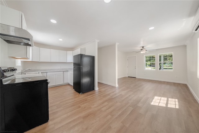 kitchen with black appliances, white cabinetry, ornamental molding, and light hardwood / wood-style flooring