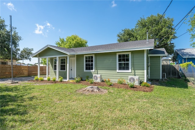 view of front of house featuring a front yard and ac unit