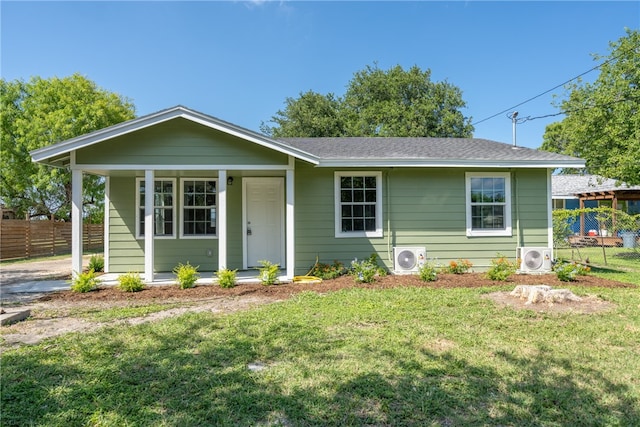 view of front of home with a front lawn and ac unit