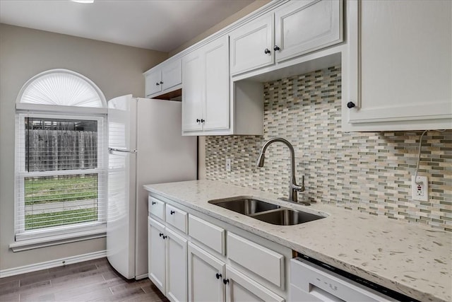 13656 Teague, Corpus Christi, TX 78410 - kitchen featuring a sink, white appliances, white cabinetry, tasteful backsplash, and light stone counters