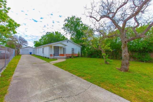 view of front of home with a front lawn, a garage, and an outdoor structure