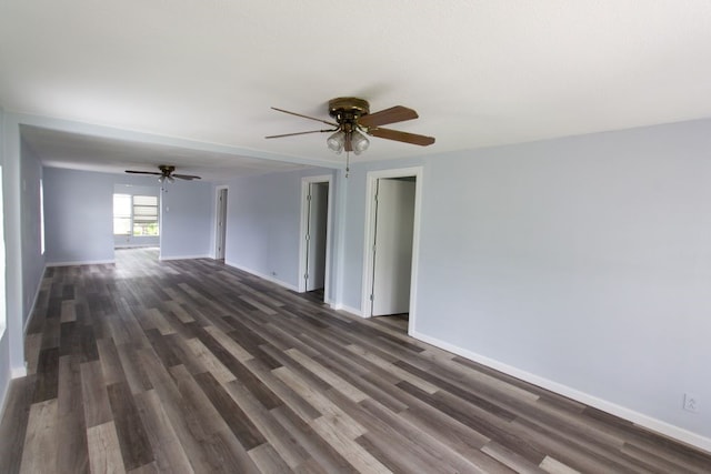 empty room with dark hardwood / wood-style flooring and ceiling fan