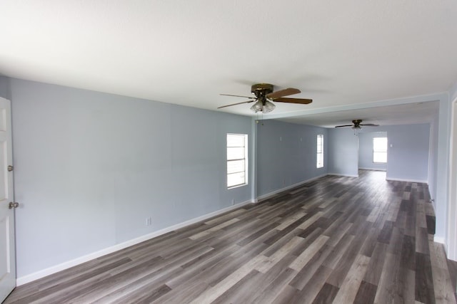 spare room featuring a wealth of natural light, dark wood-type flooring, and ceiling fan