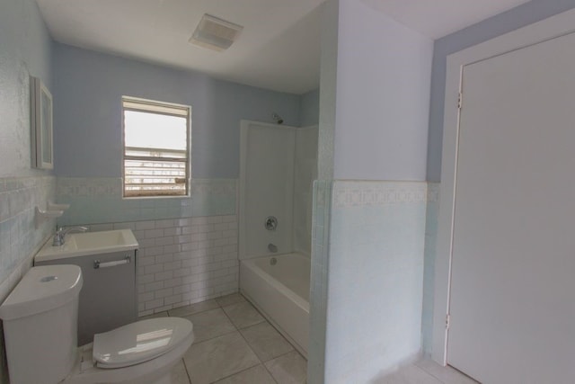 full bathroom featuring tile walls, bathing tub / shower combination, tile patterned floors, vanity, and toilet