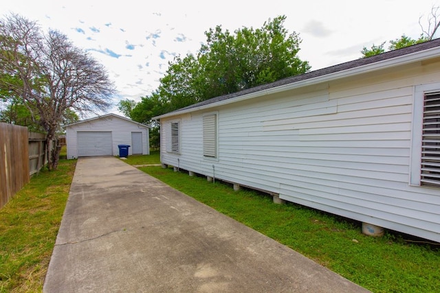 view of side of property with an outbuilding, a garage, and a lawn