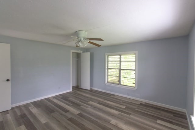 unfurnished room featuring ceiling fan and dark hardwood / wood-style floors