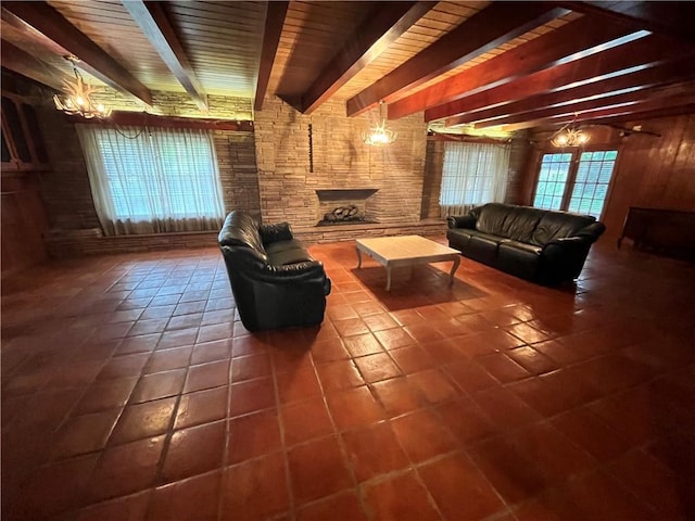 tiled living room featuring beam ceiling, a notable chandelier, and a stone fireplace