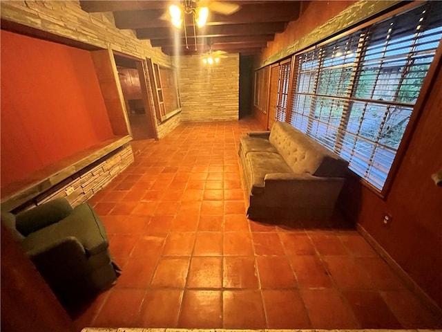 hall with beamed ceiling and light tile patterned floors