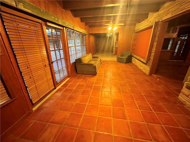 hall with tile patterned flooring and beam ceiling