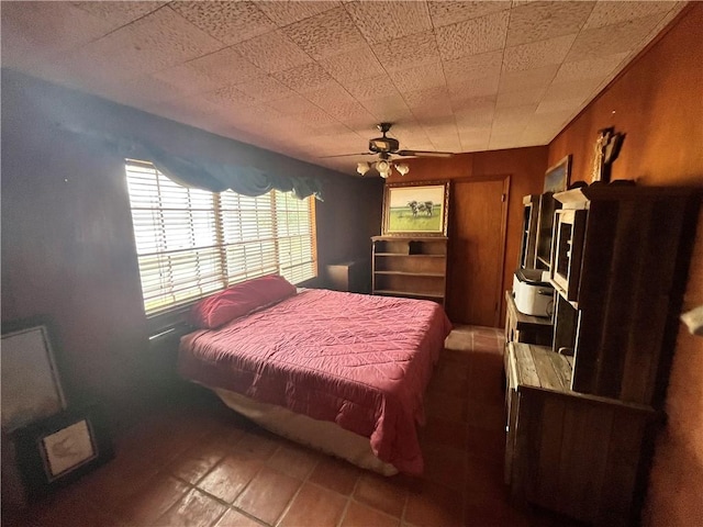 bedroom with ceiling fan and a closet