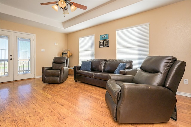 living room with french doors, light wood-type flooring, and plenty of natural light