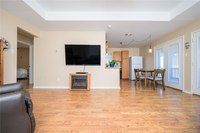 living room featuring french doors and light wood-type flooring