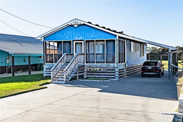 view of front of property featuring a sunroom