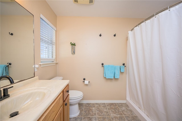 bathroom with a shower with shower curtain, tile patterned floors, vanity, and toilet