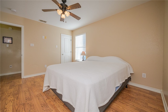 bedroom with ceiling fan and light hardwood / wood-style flooring