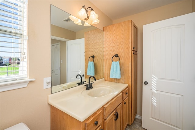 bathroom featuring vanity and a chandelier