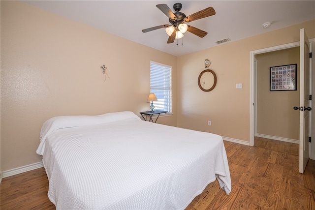 bedroom with ceiling fan and wood-type flooring