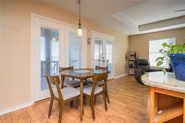 dining area with light wood-type flooring and french doors