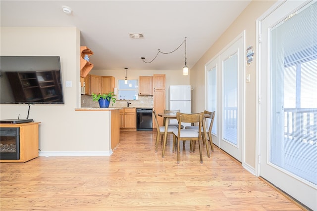 dining area with light hardwood / wood-style flooring and sink