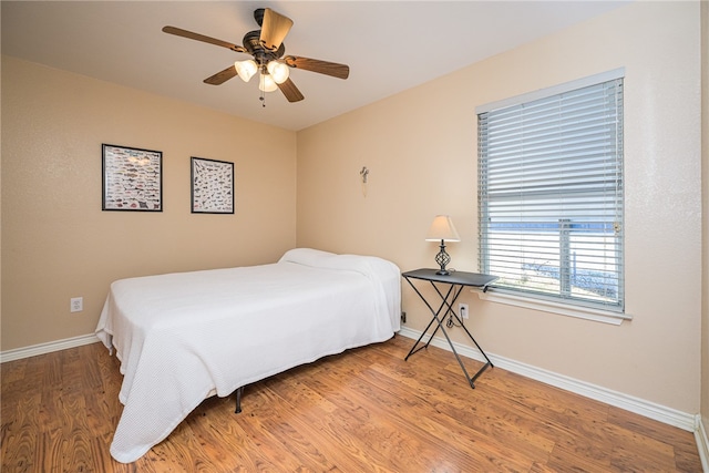 bedroom featuring wood-type flooring and ceiling fan