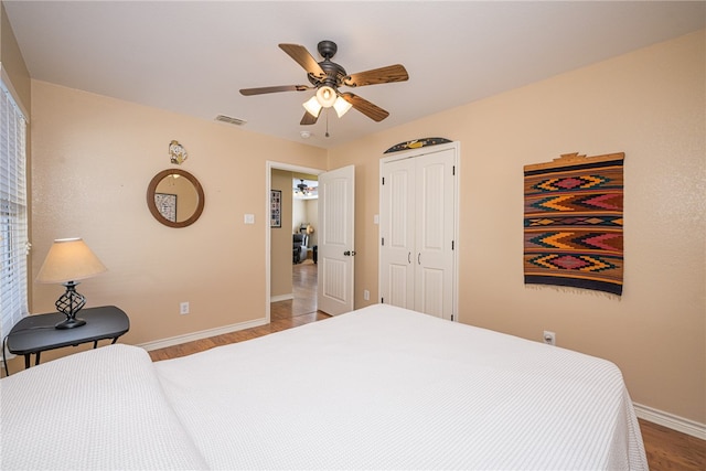 bedroom featuring a closet, hardwood / wood-style flooring, and ceiling fan