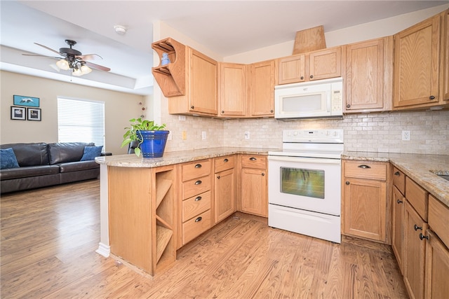 kitchen with light wood-type flooring, white appliances, kitchen peninsula, and backsplash