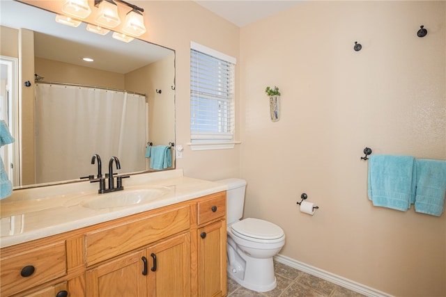 bathroom featuring tile patterned flooring, vanity, and toilet