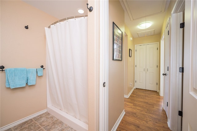 bathroom with curtained shower and wood-type flooring