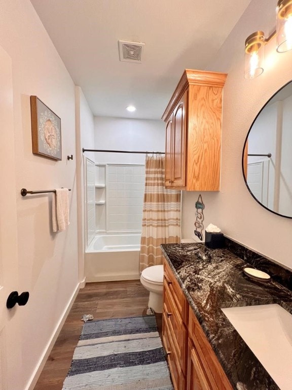 full bathroom featuring toilet, shower / tub combo, vanity, and hardwood / wood-style floors