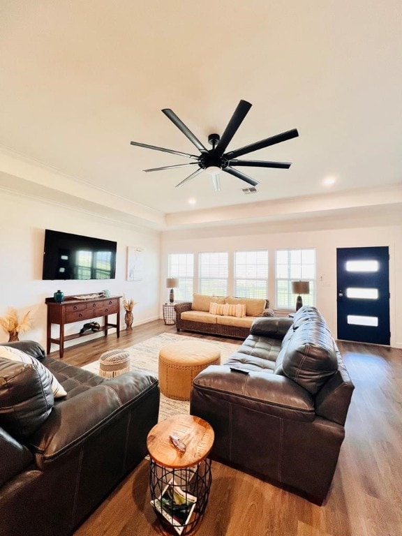 living room featuring hardwood / wood-style floors and ceiling fan