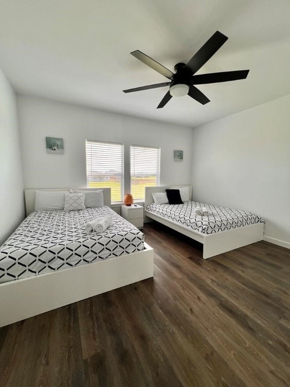 bedroom featuring dark hardwood / wood-style flooring and ceiling fan