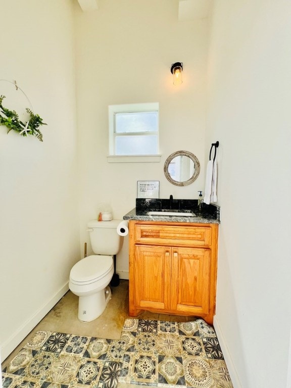 bathroom with tile patterned floors, vanity, and toilet