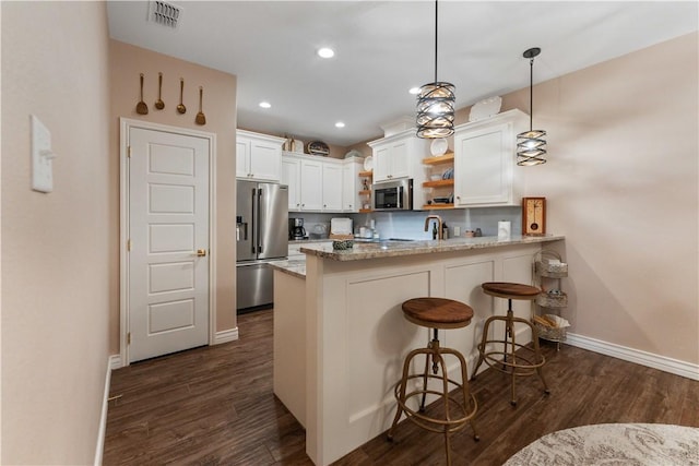 5422 Neela Ln, Corpus Christi, TX 78413 - kitchen with appliances with stainless steel finishes, open shelves, a peninsula, white cabinetry, and dark wood finished floors