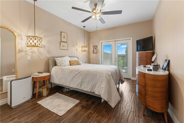 bedroom featuring dark wood-type flooring, ceiling fan, french doors, and access to outside