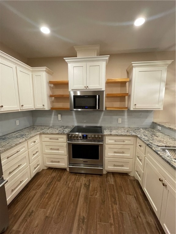 kitchen featuring dark hardwood / wood-style flooring, white cabinets, backsplash, light stone countertops, and appliances with stainless steel finishes