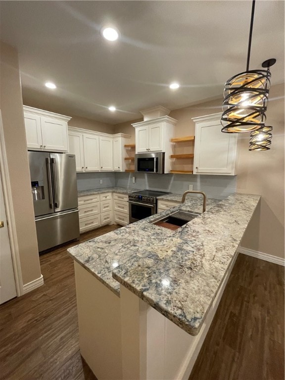 kitchen with kitchen peninsula, pendant lighting, white cabinets, and stainless steel appliances